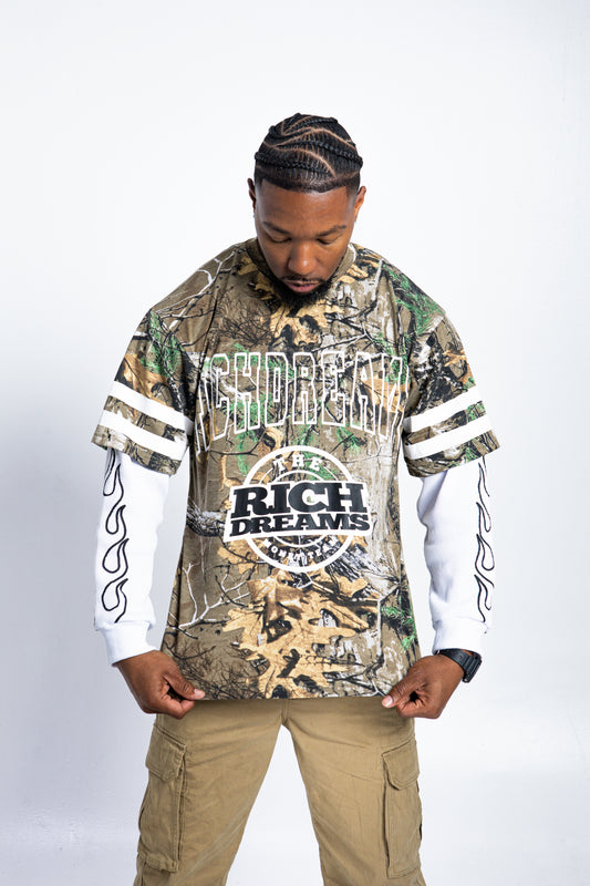 Model wearing Rich Dreams camo thermal long sleeve streetwear top